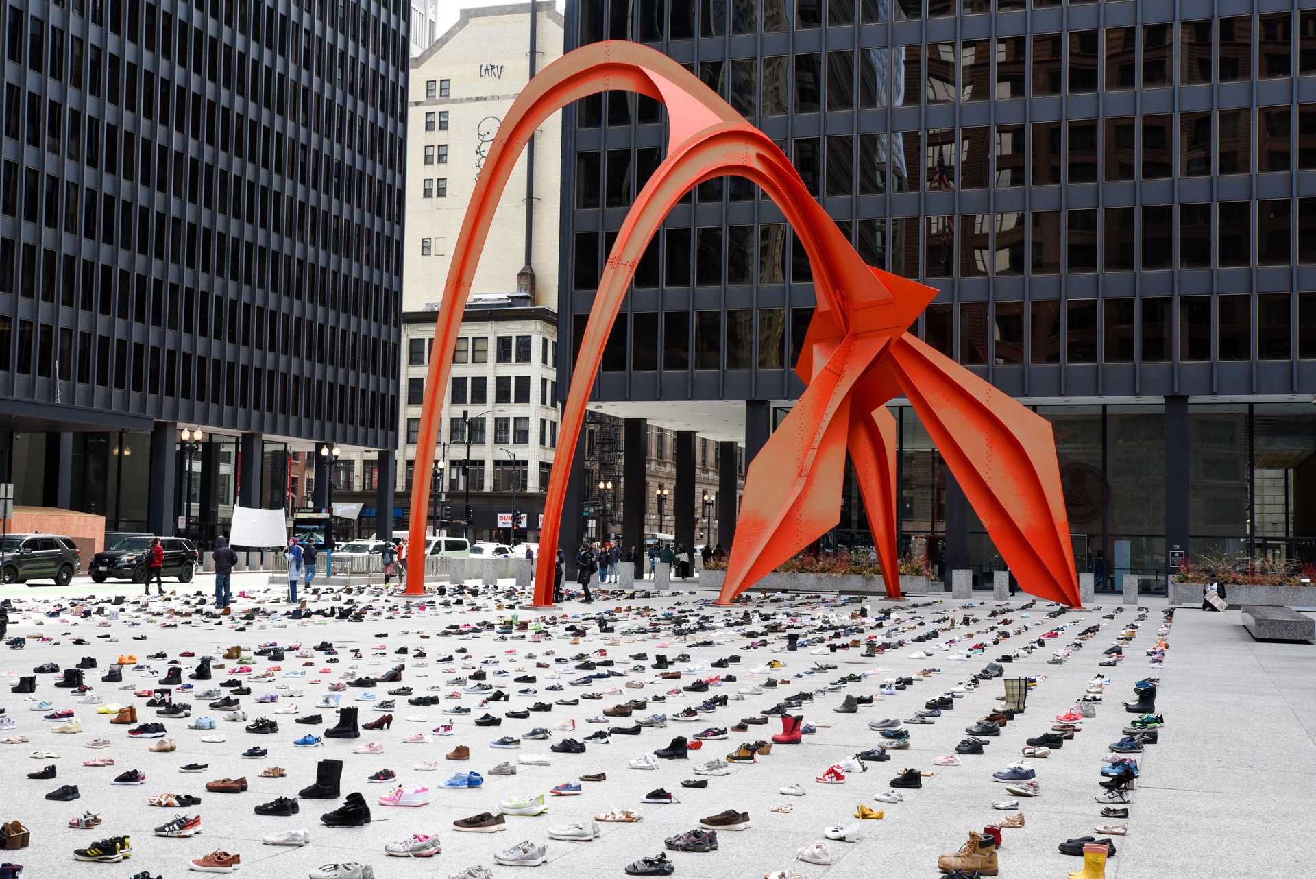 An image of Chicago's Daley Plaza, filled with shoes that are spaced evenly representing the dead of Gaza